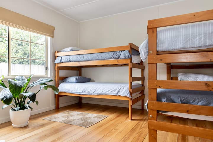 Cottage Bunk Bedroom | A comfortable bedroom for children and adults with two bunk beds and wardrobe storage.