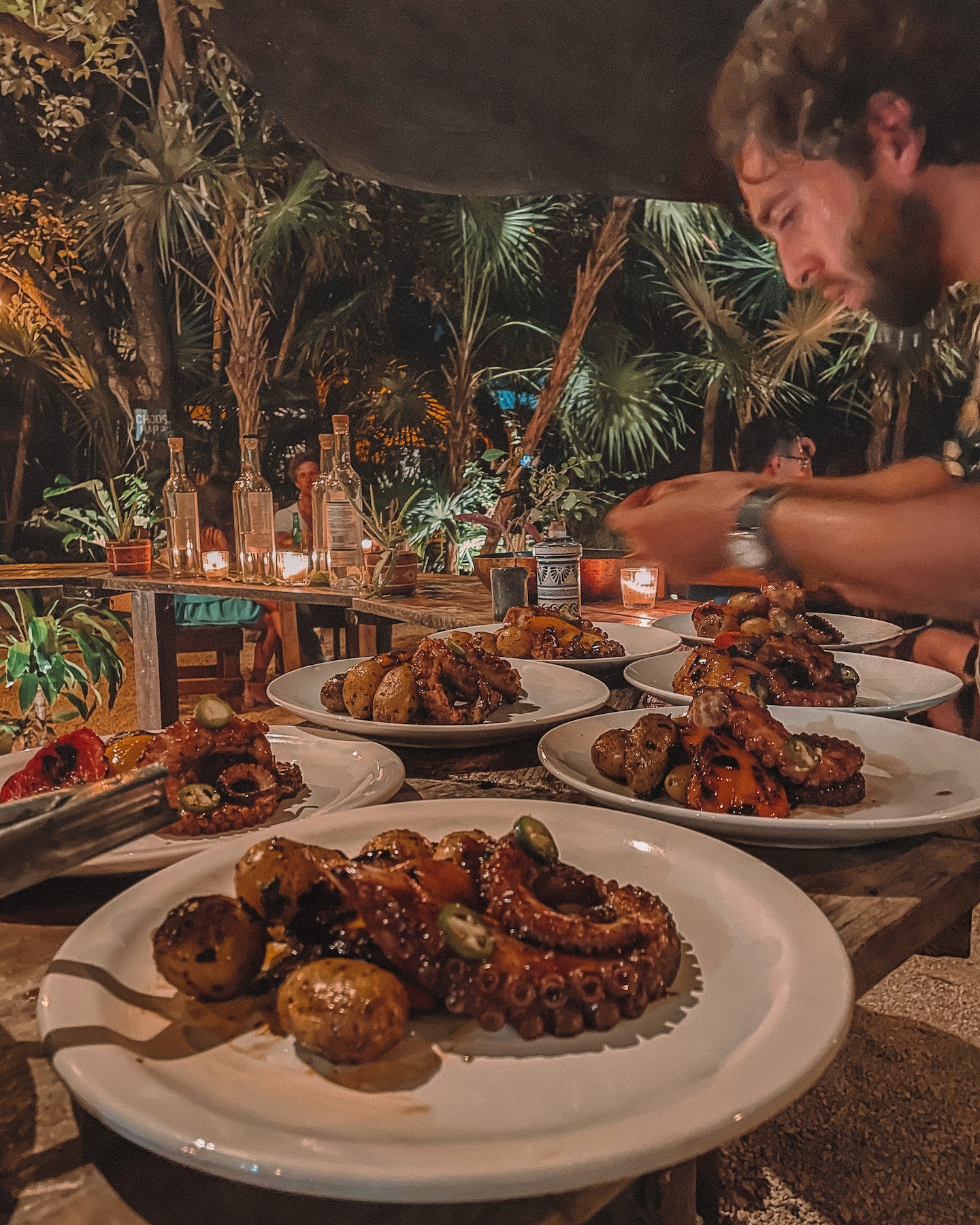 man preparing dinner in the jungle