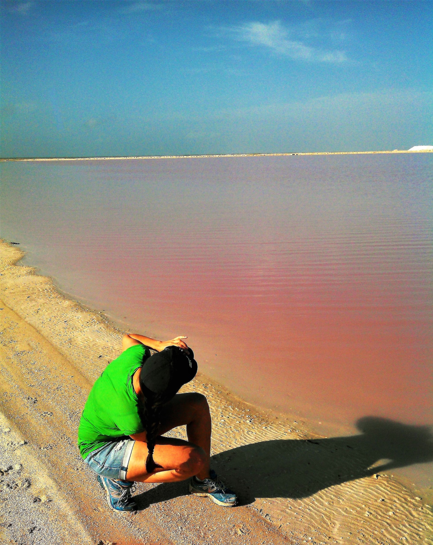 man taking photos of las coloradas pink lakes mexico