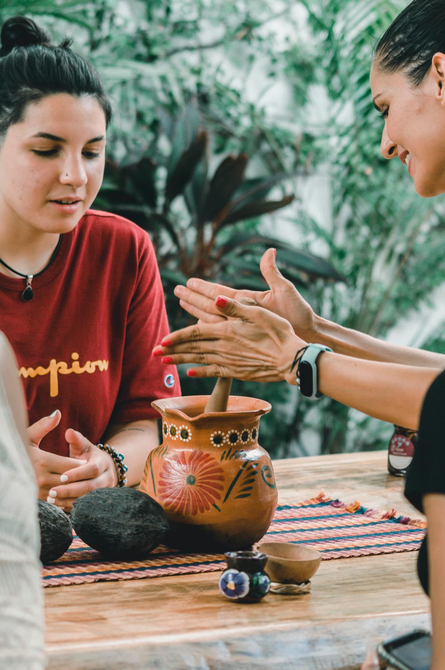 woman teaching a guest how to make chocolate drink