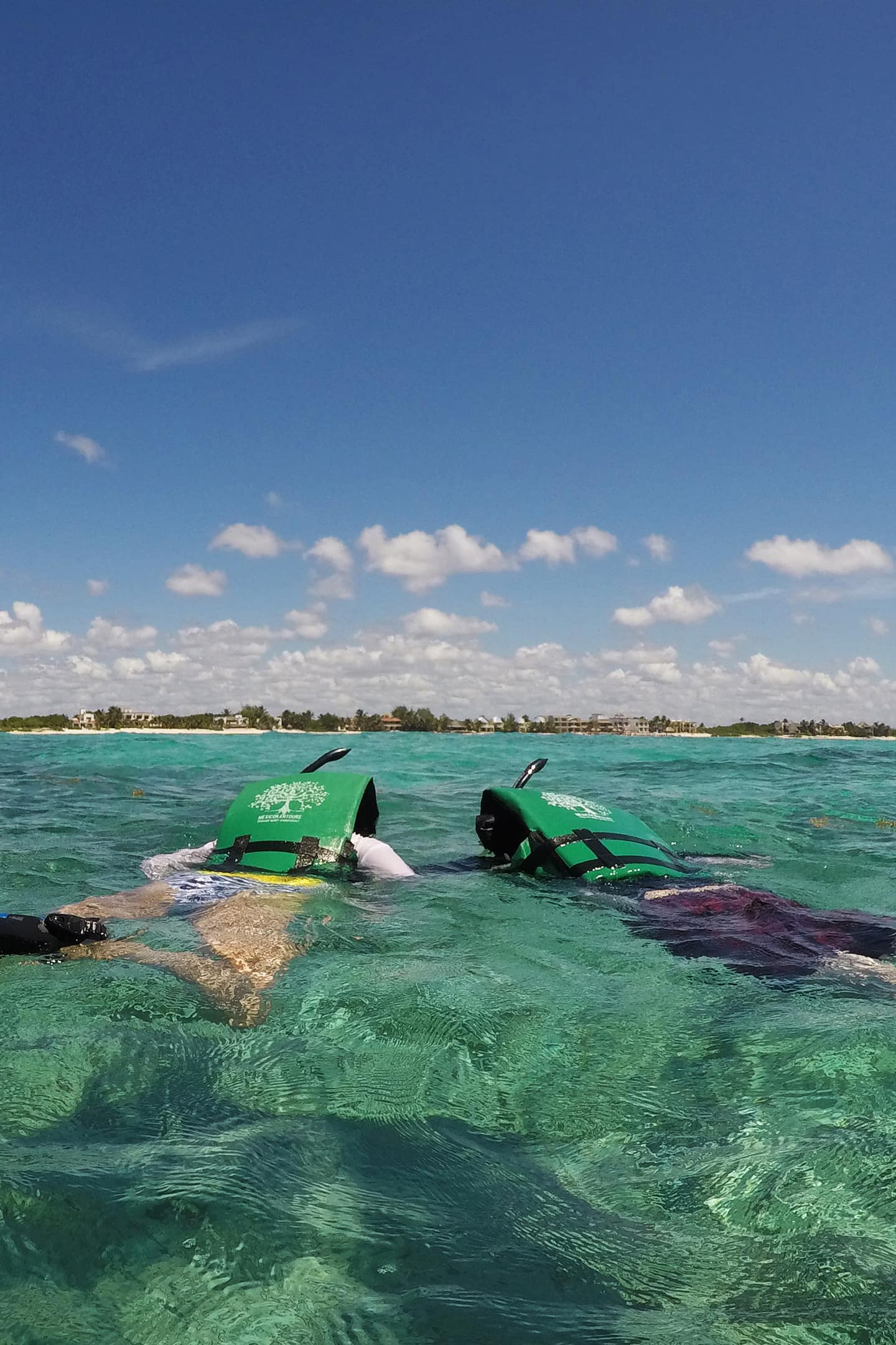 two people snorkeling in tulum mexico