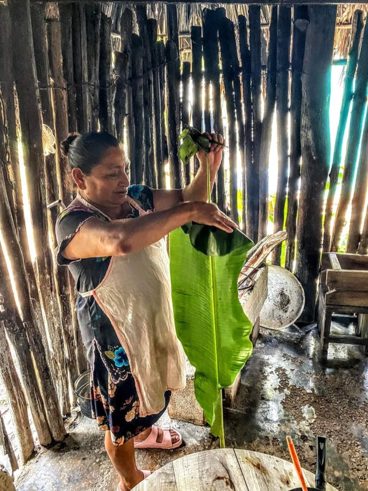 mayan woman preparing food in a traditional kitchen in tulum mexico