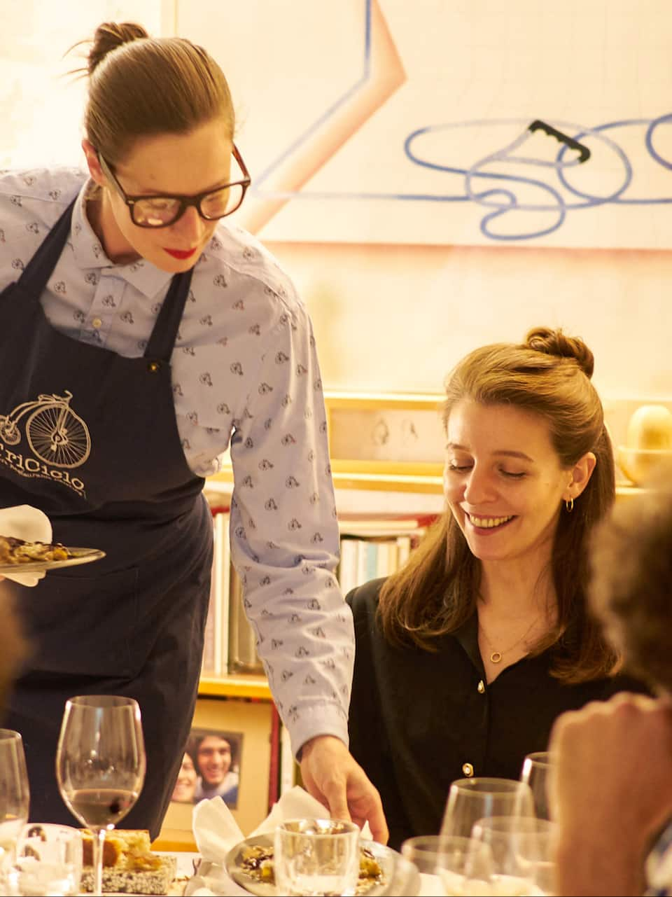 Woman being served a gourmet meal by chef