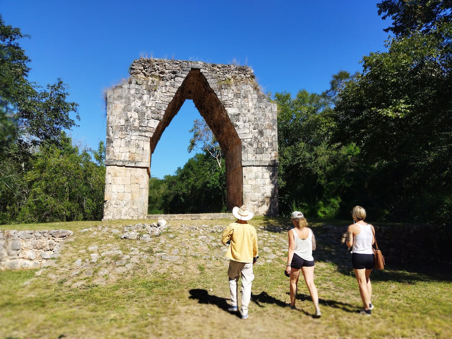 three tourists in uxmal ruins