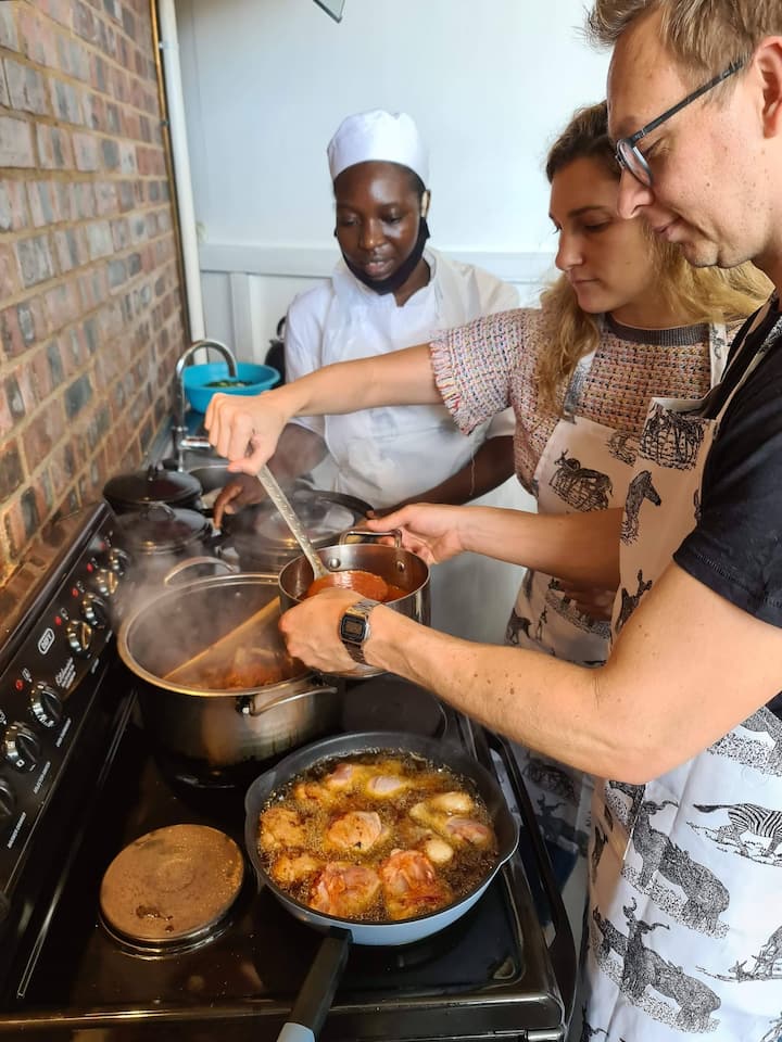 Guests cooking an African meal