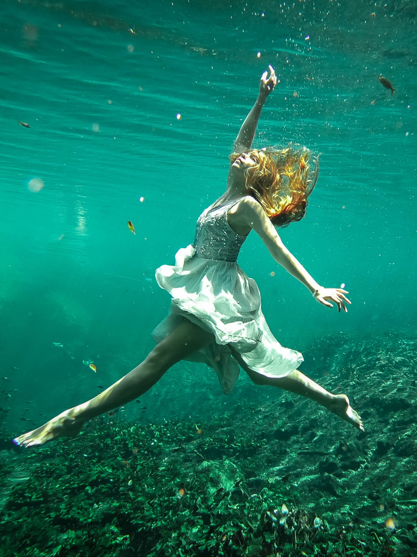woman in a dress doing underwater photoshoot in tuum mexico