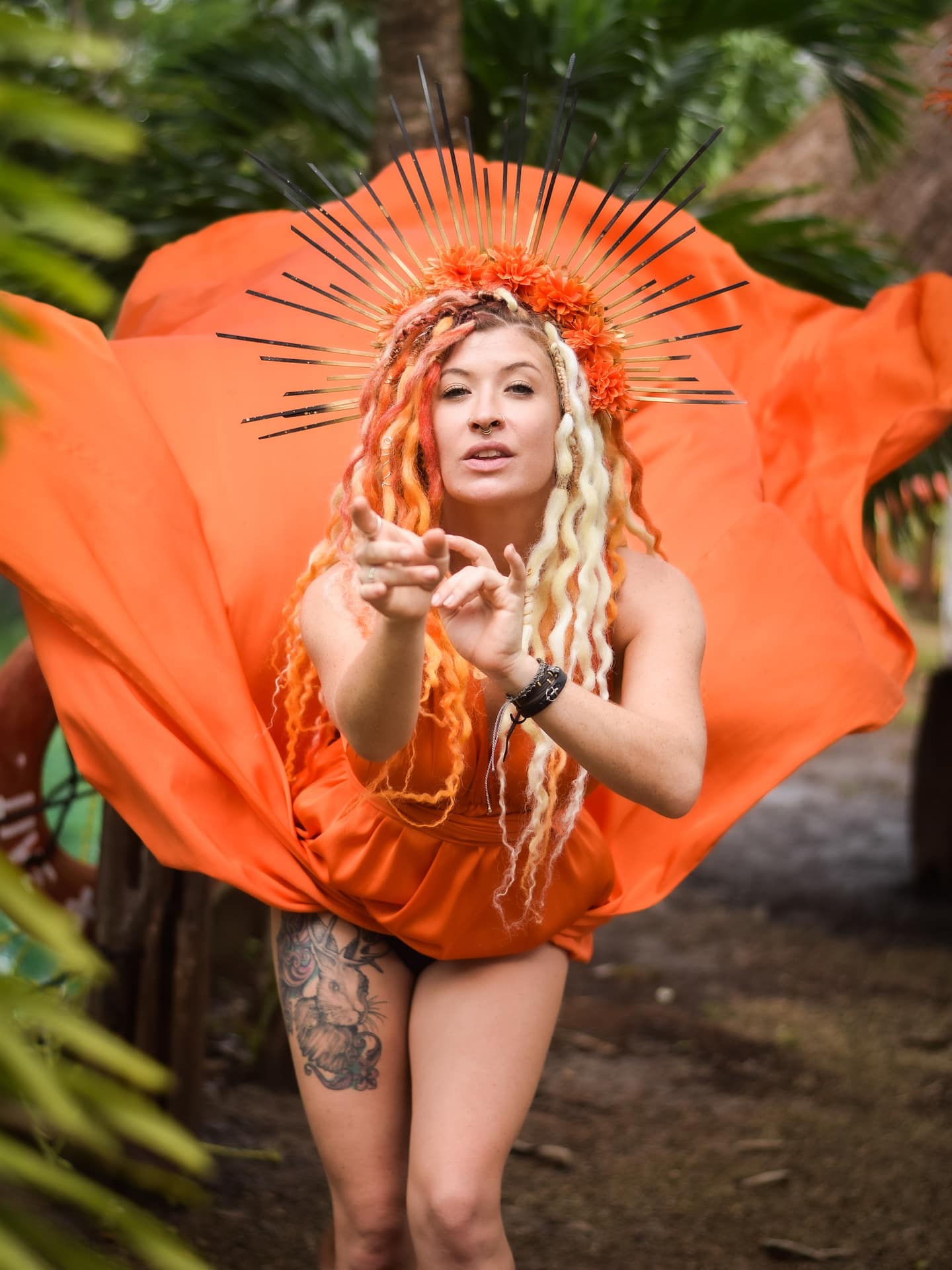 woman on the beach wearing a long, flowing yellow dress for the fiying dress tulum photoshoot