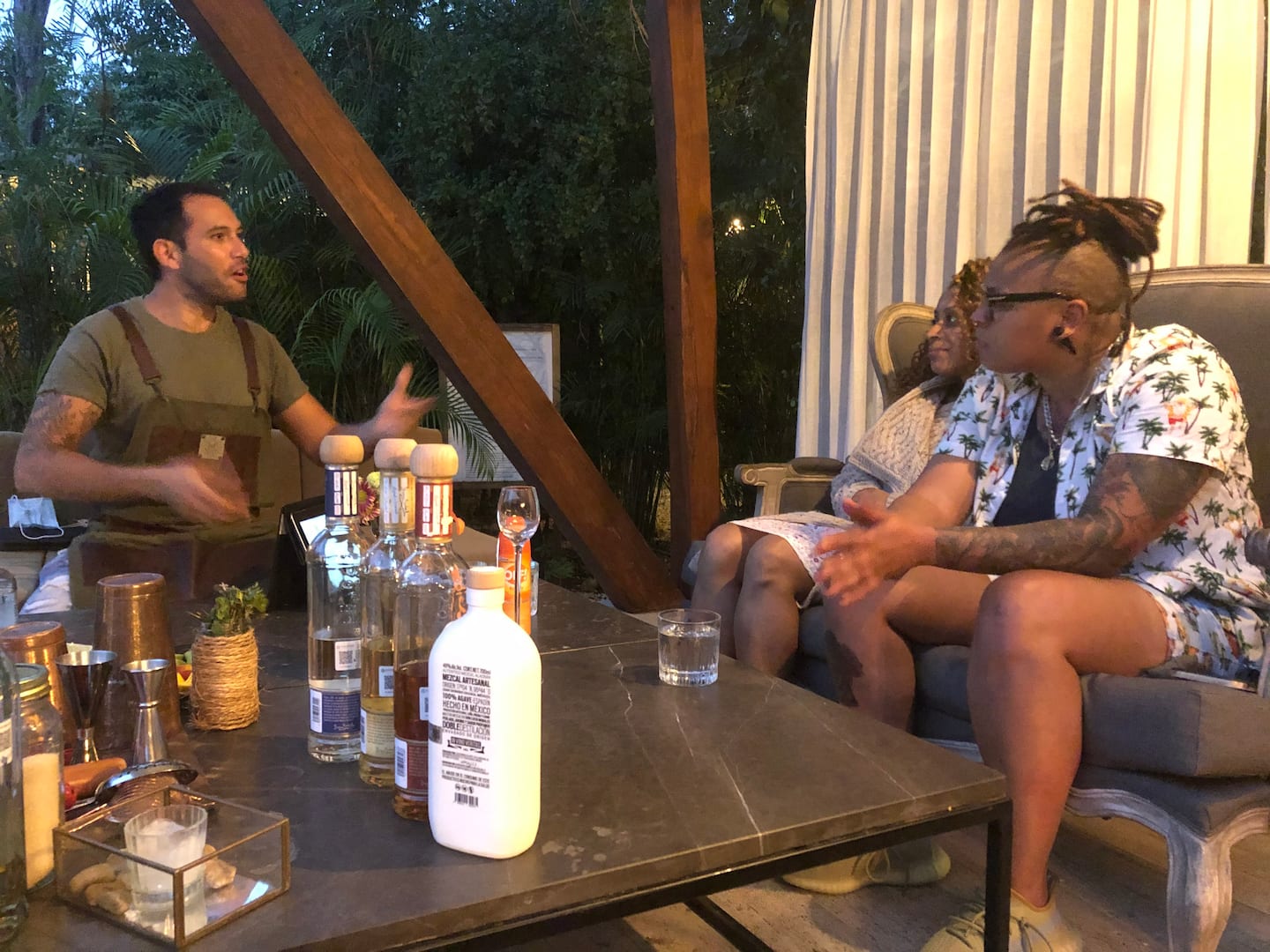 bartender entertaining a guest during Tulum mezcal tasting