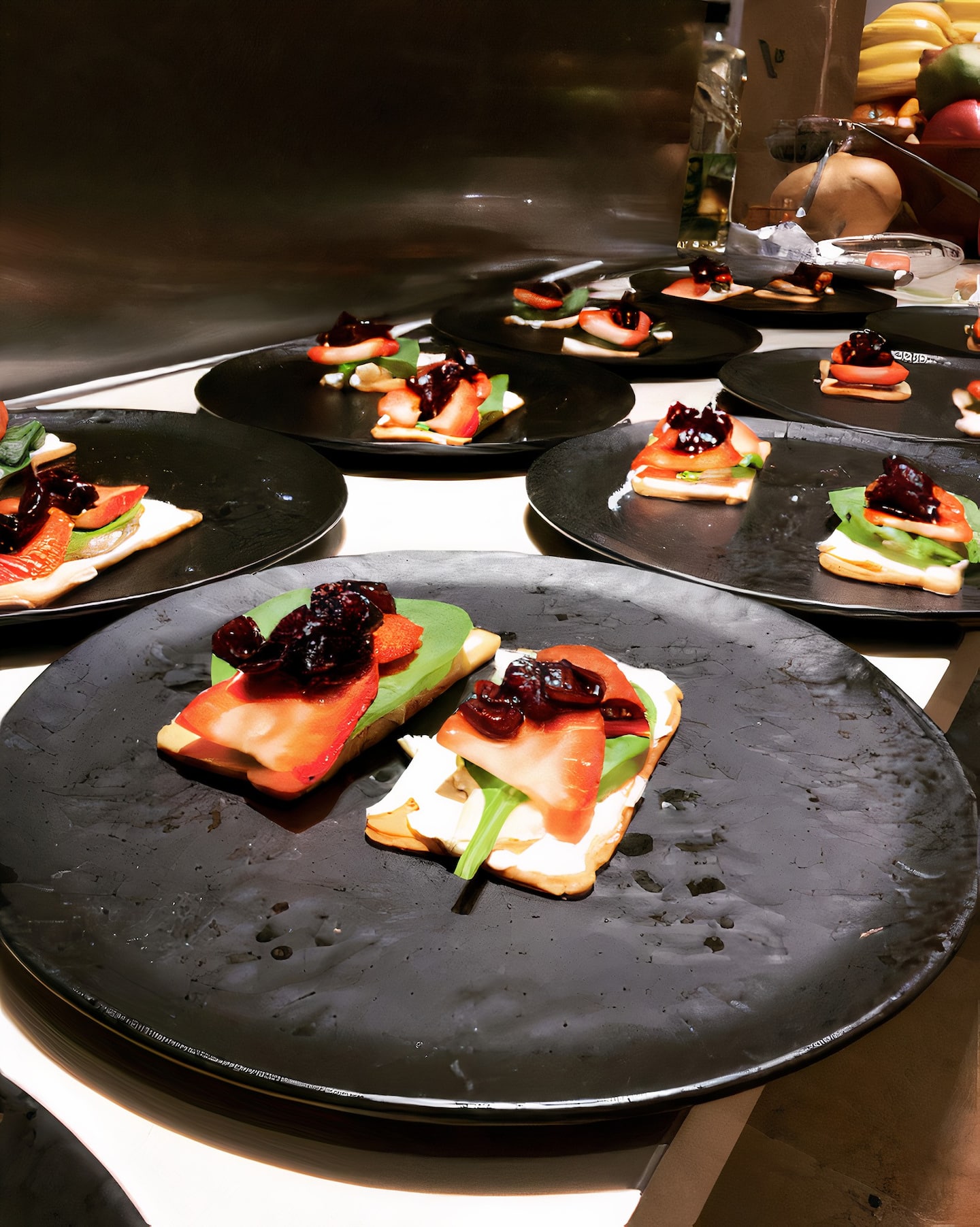 gourmet dishes on black plates