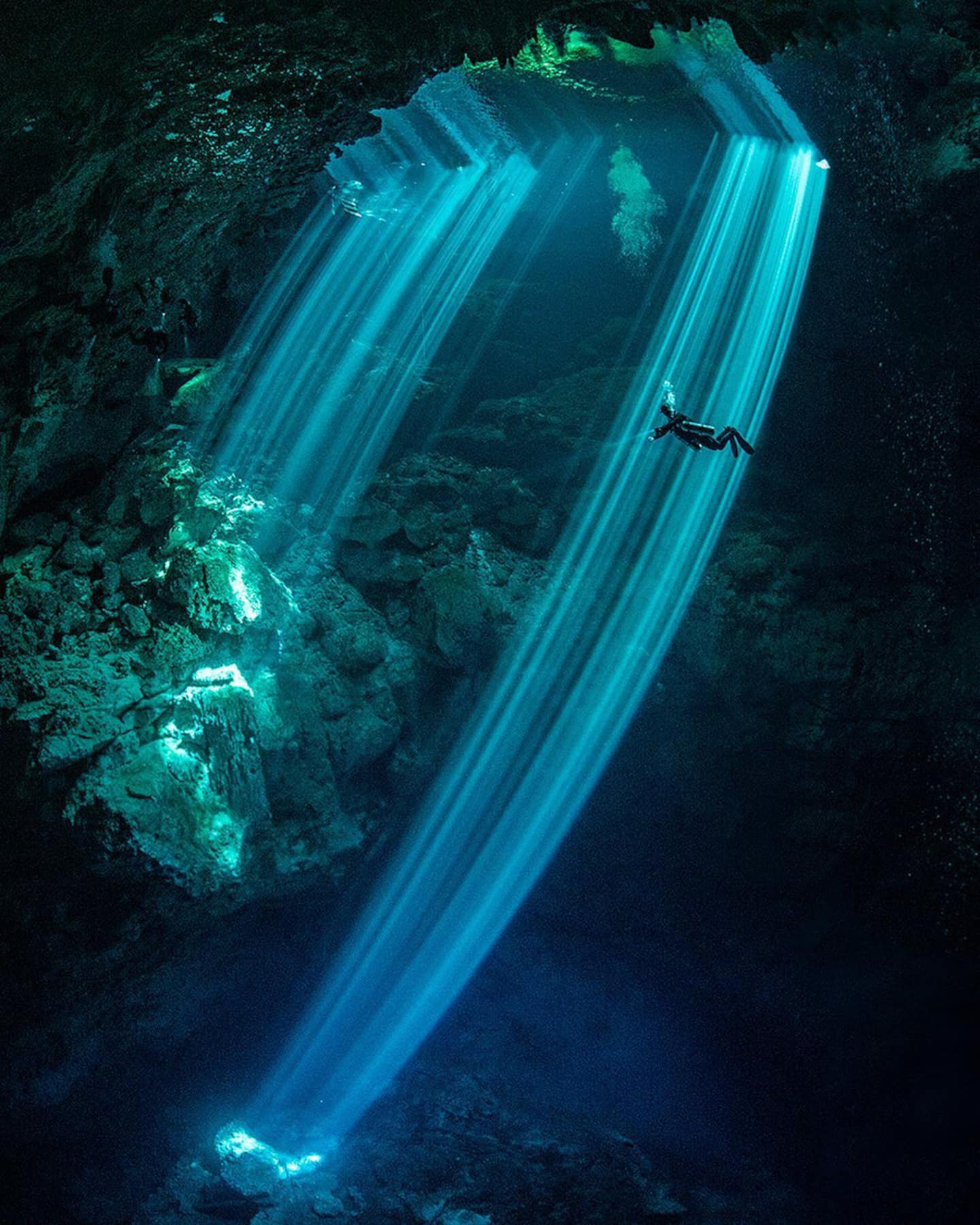 diver diving in cenote el pit mexico