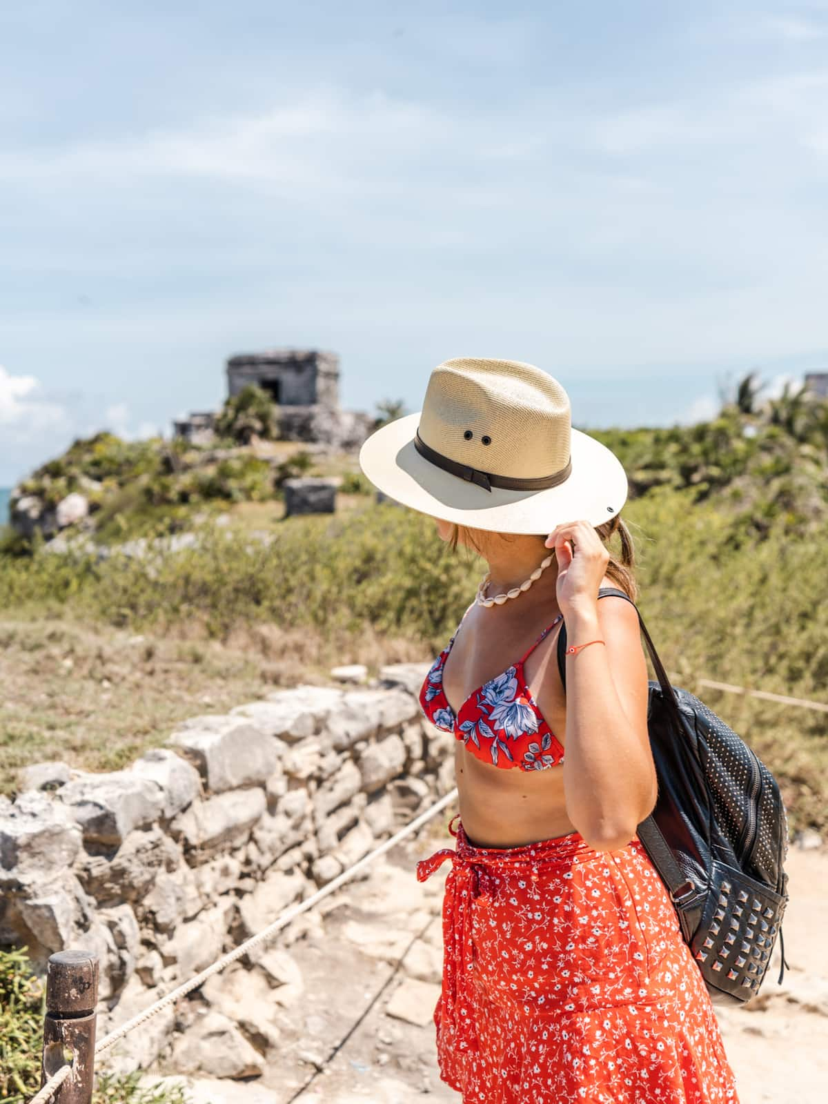 woman in floral dress visiting the Tulum ruins