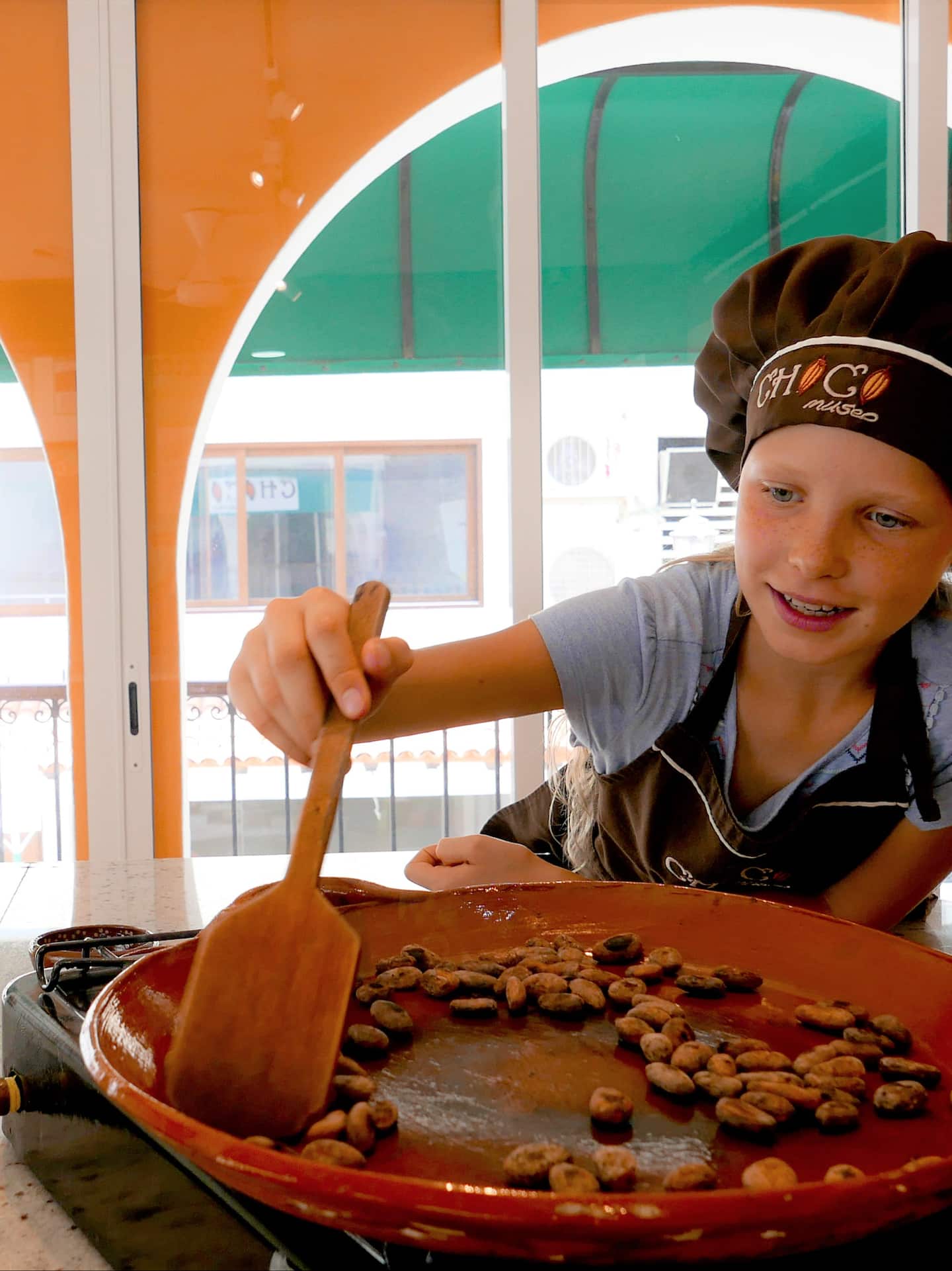 girl roasting cacao beans