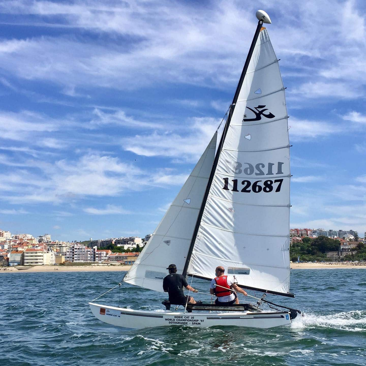 tourist learning how to sail a catamaran with an instructor