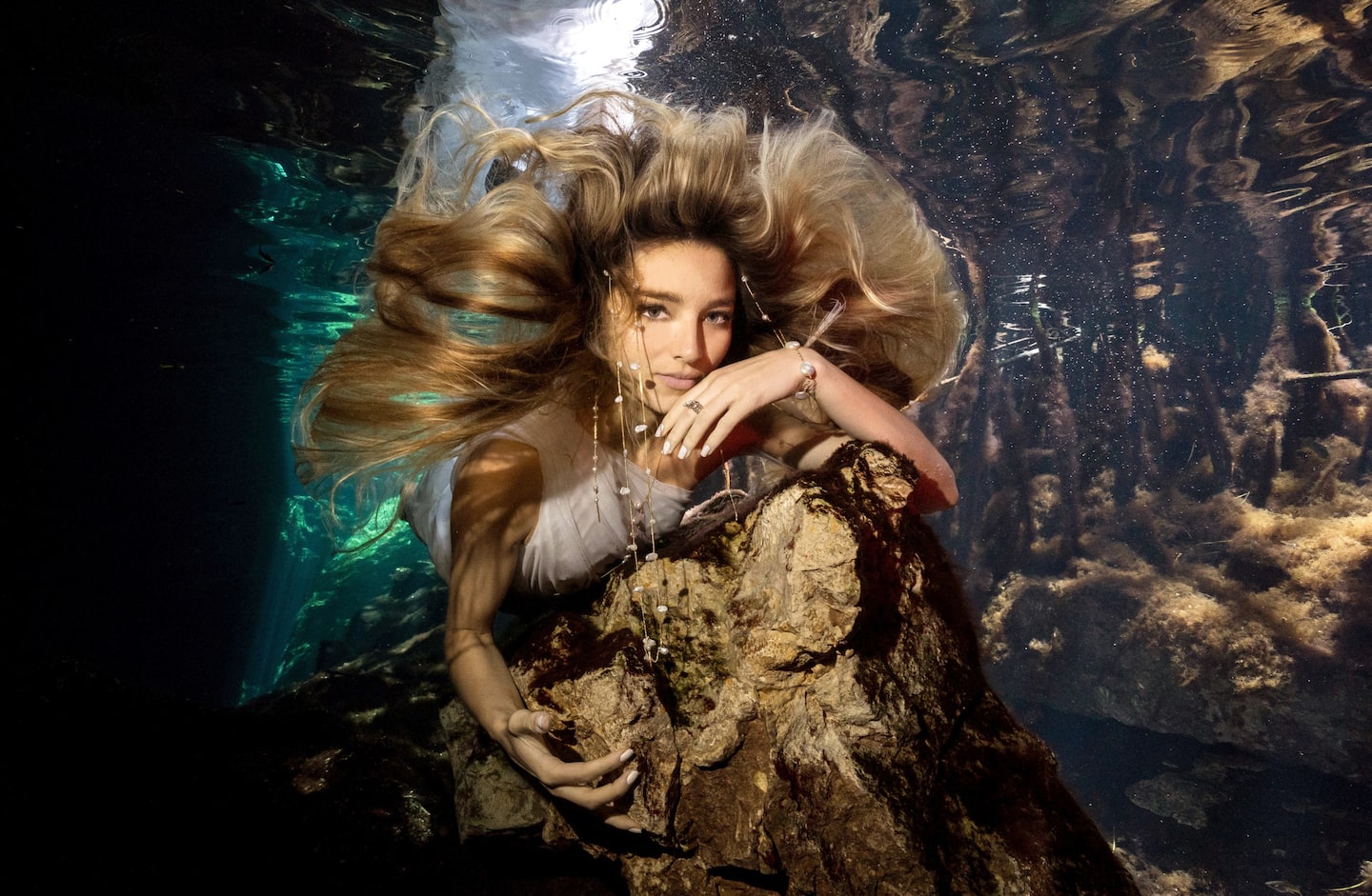 Woman in yellow dress twirling around at Coba, the Best Mayan Ruins in the Yucatan, located in Tulum, Mexico