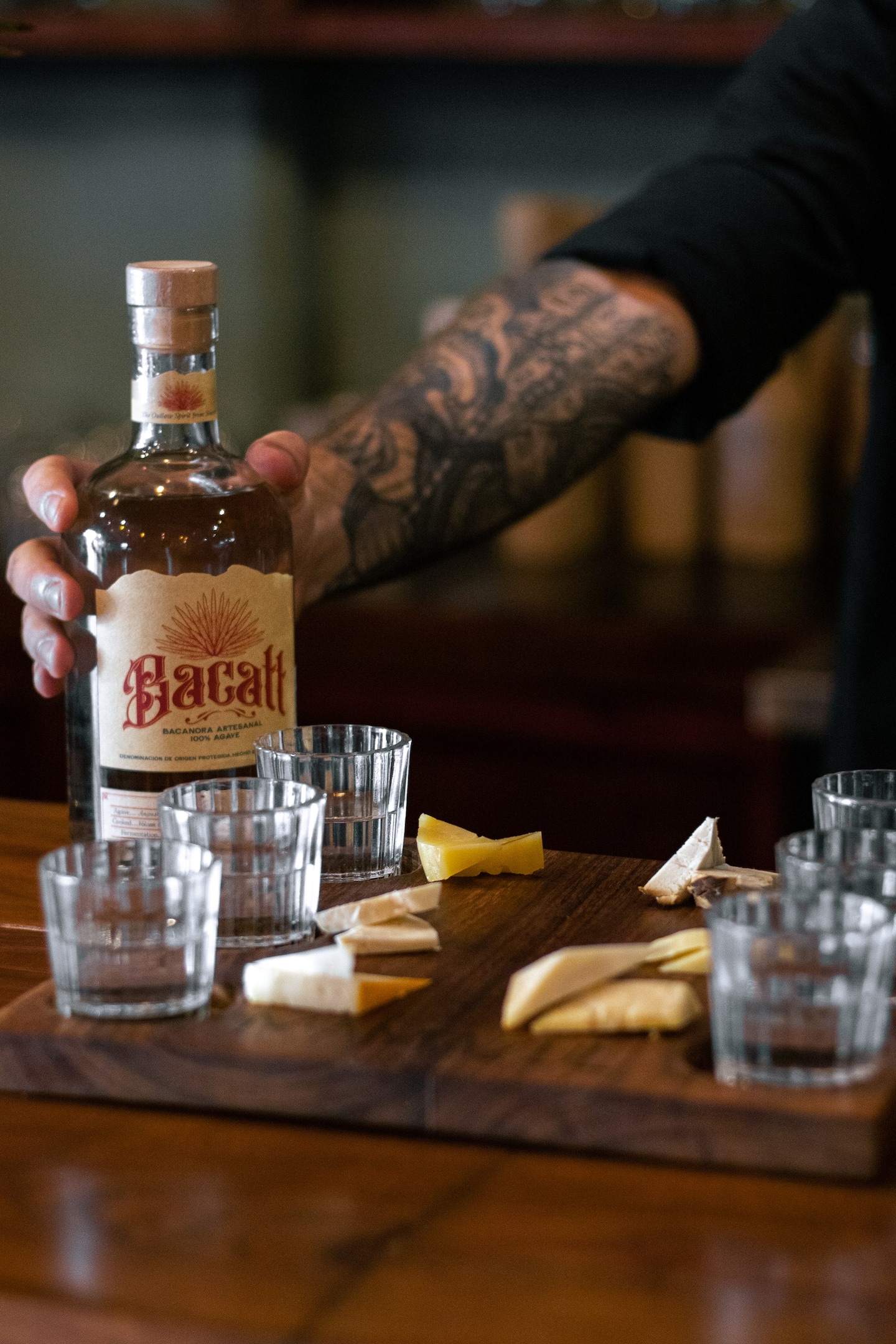 people holding shots of mezcal