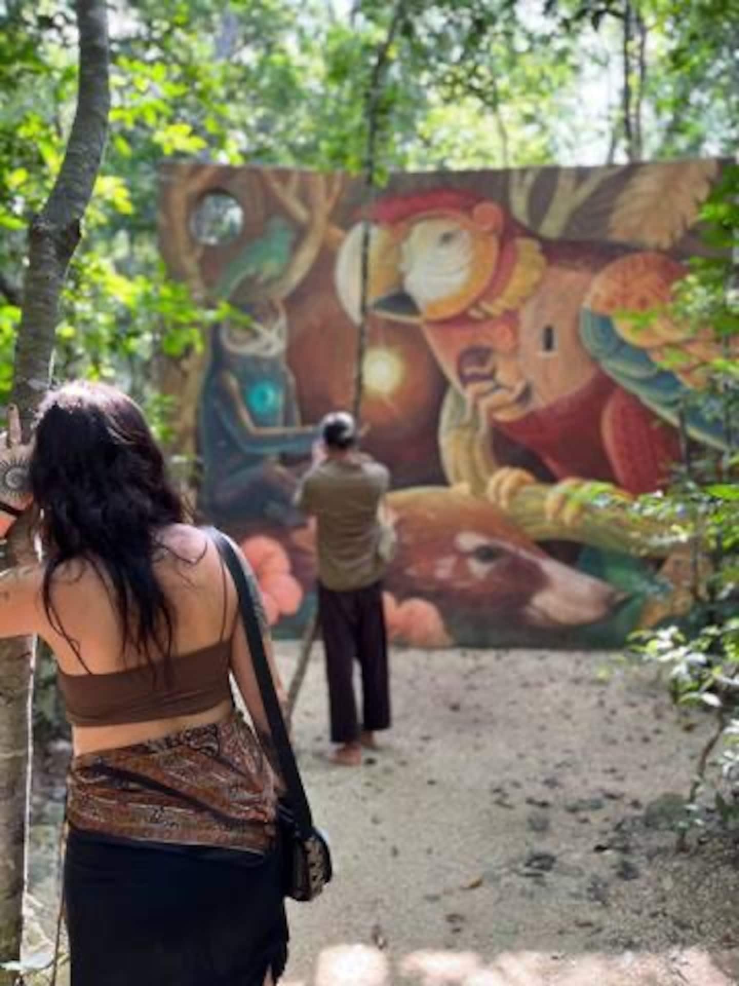 woman posing near tulum mural