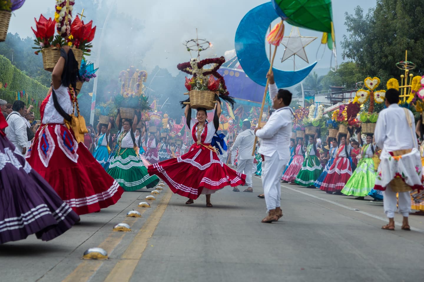 people dancing in the street in traditional clothes in Oaxaca Mexico