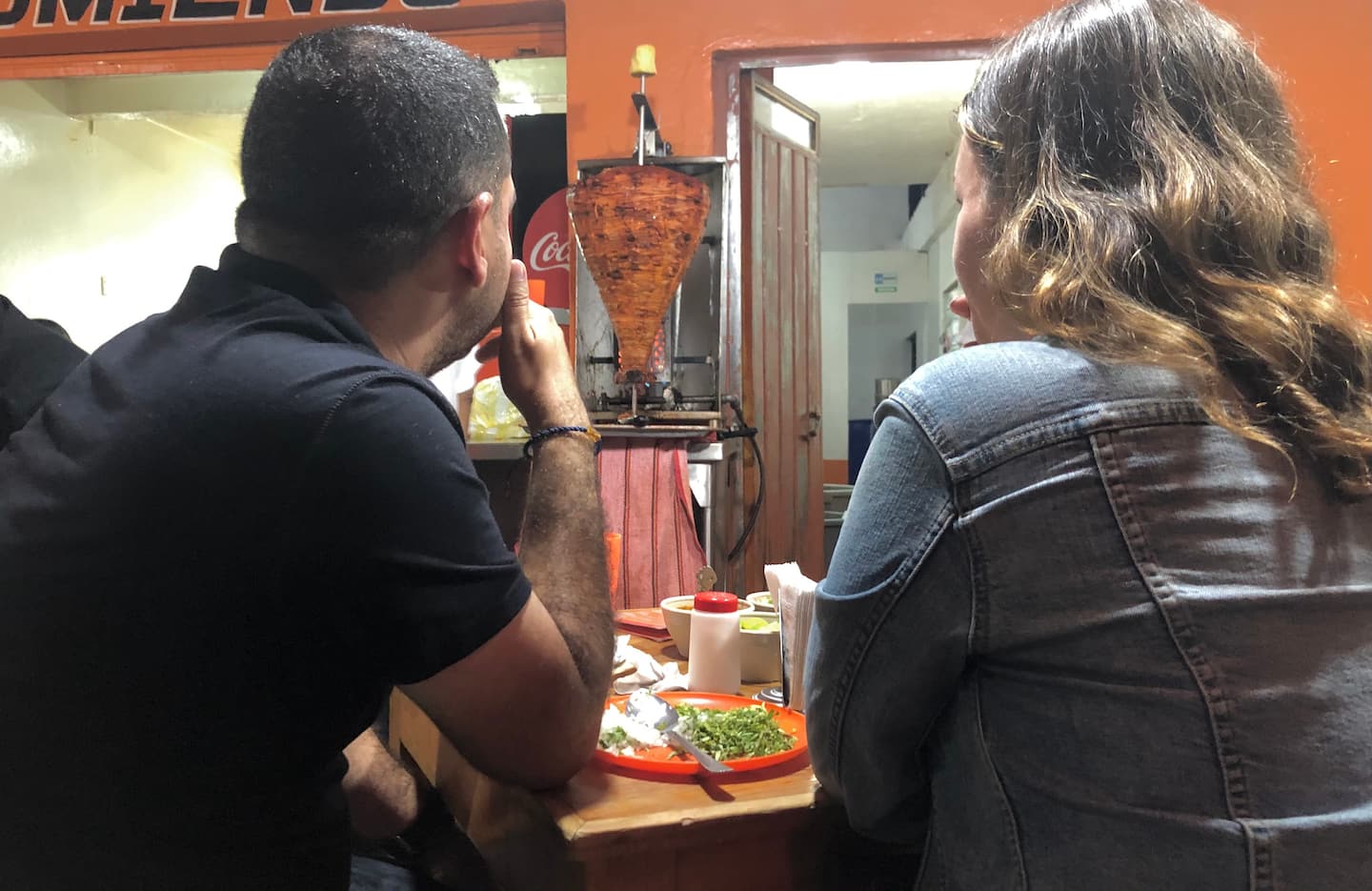 two people waiting for their tacos to arrive