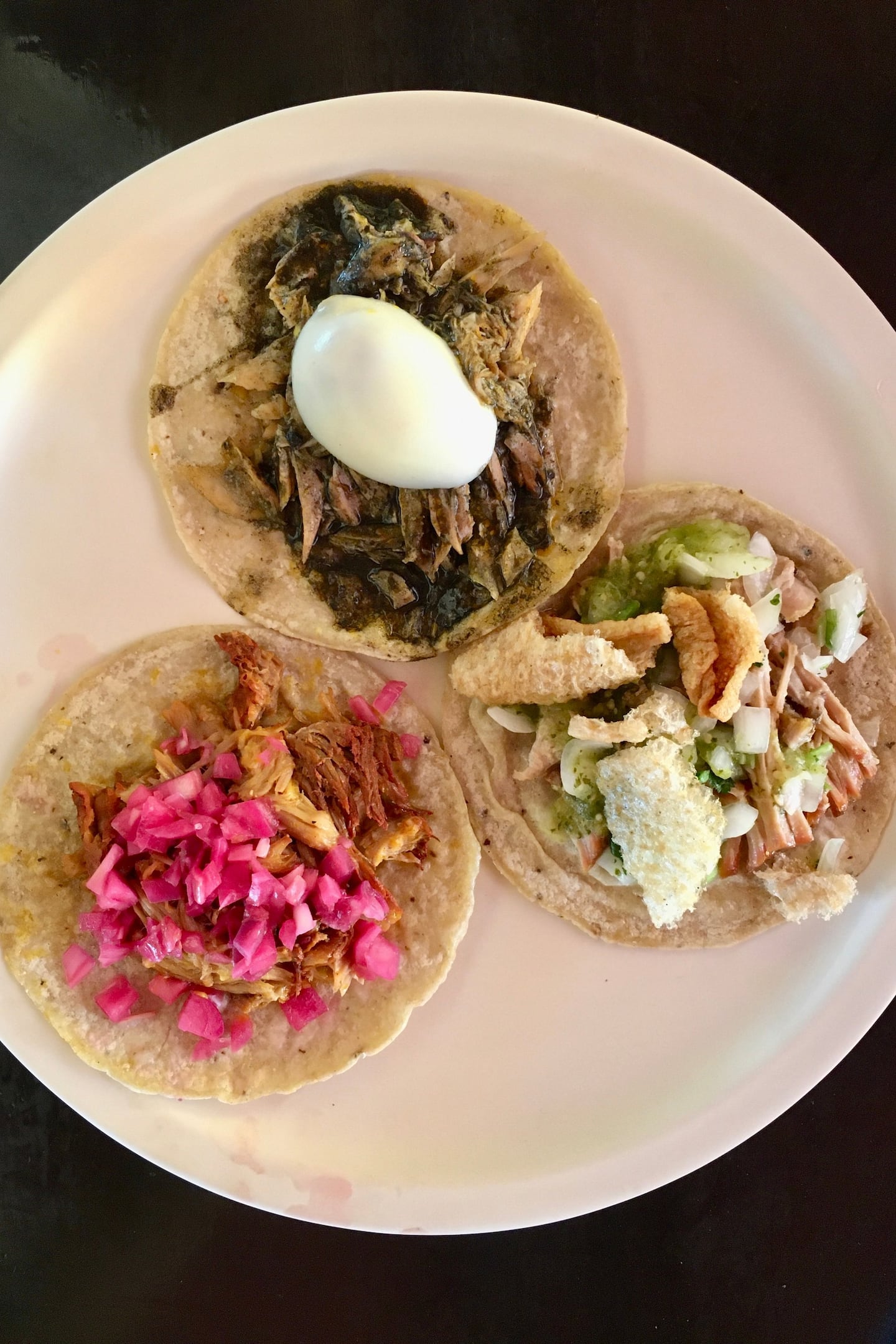 plate with three different types of tacos on a food tour in tulum mexico