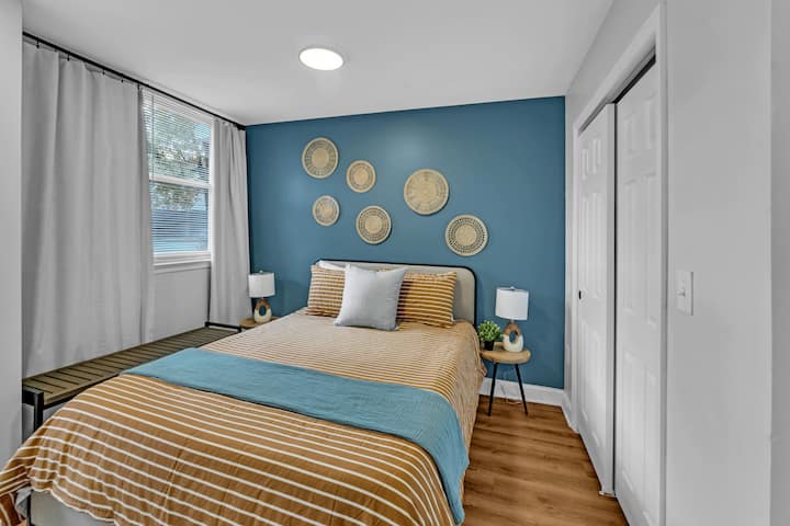 Pumzika katika chumba hiki cha kulala chenye utulivu kilicho na kuta nzuri za bluu na kitanda cha kifahari.