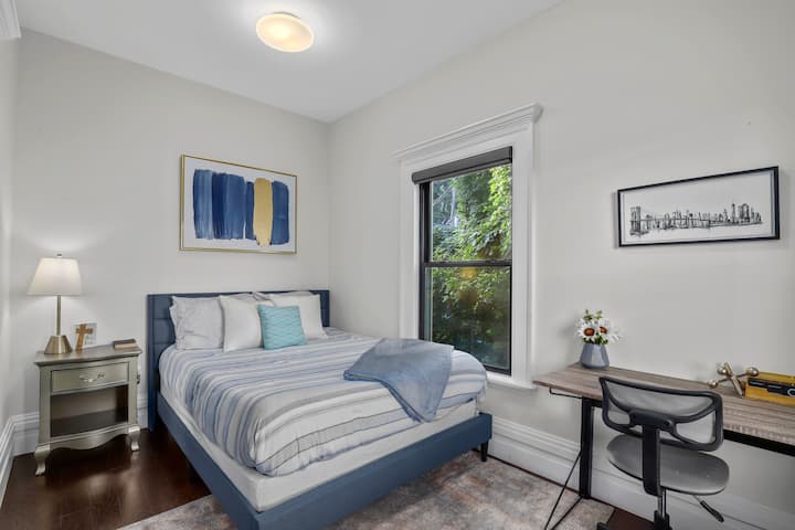Comfortable bedroom with stylish decor and a dedicated workspace.
