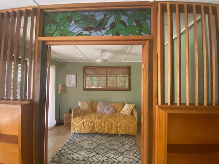 With a single size bed, the second bedroom has a built-in robe and a sliding door that looks out into the garden and opens onto the back patio. The bedroom has timber louver doors that close to separate it from the living room.