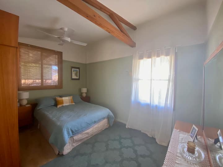 The master bedroom features a very comfortable pillow-top Queen sized bed with side tables. There is a shutter on the front window, which makes the room dark (which is great for sleep-ins).