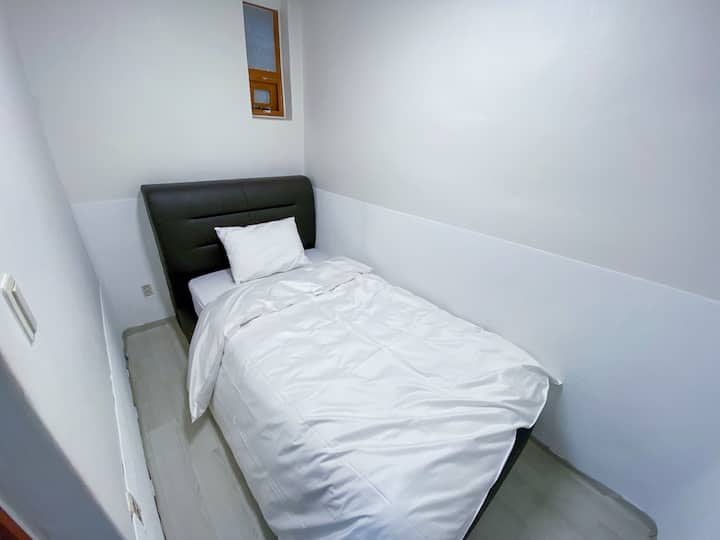A room with a super-single-sized bed