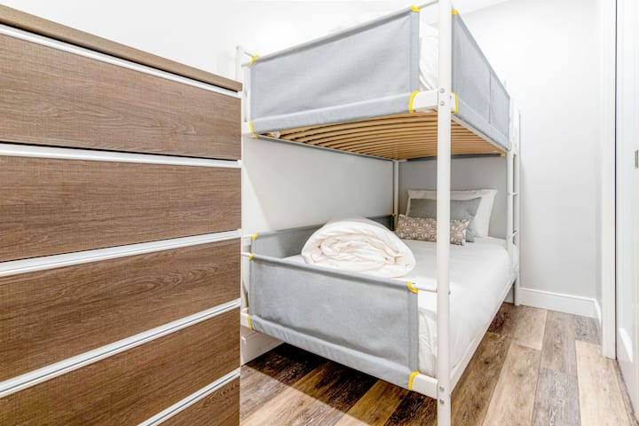 Sleeping den perfect for two children, equipped with a single-over-single bunk bed and a chest of drawers for storage.