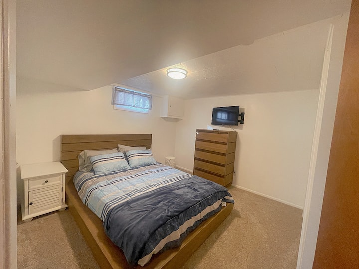 Suite Serenity: Your Home Away from Home - Discover Comfort in the 2nd Downstairs Bedroom with a Queen Bed, Spacious Closet, Dresser, and Smart TV!