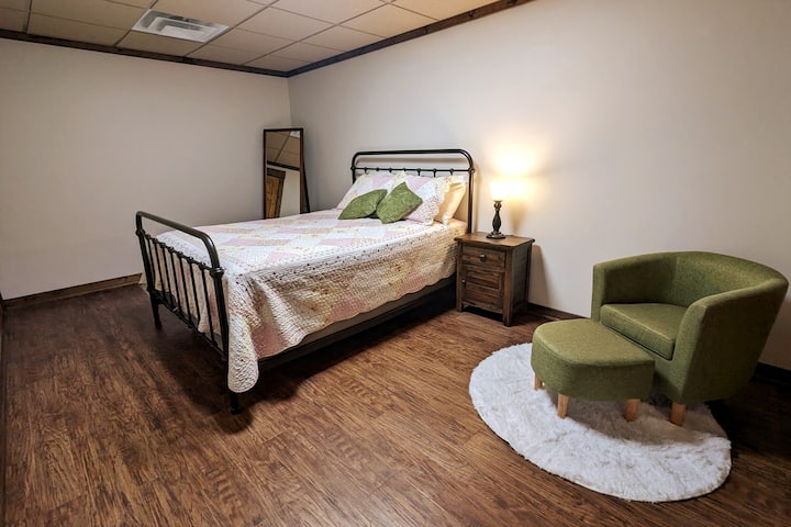 Downstairs right bedroom featuring queen size bed and comfortable reading nook.