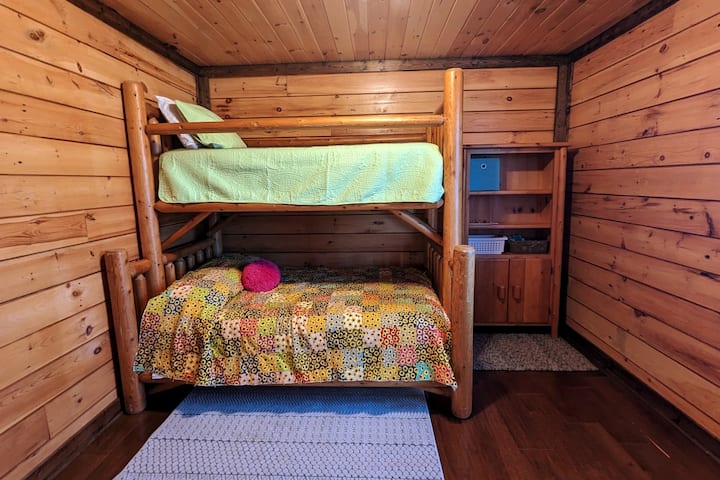 Main floor right bedroom.  Set up for kids. Double bed on the bottom and twin bed on top.