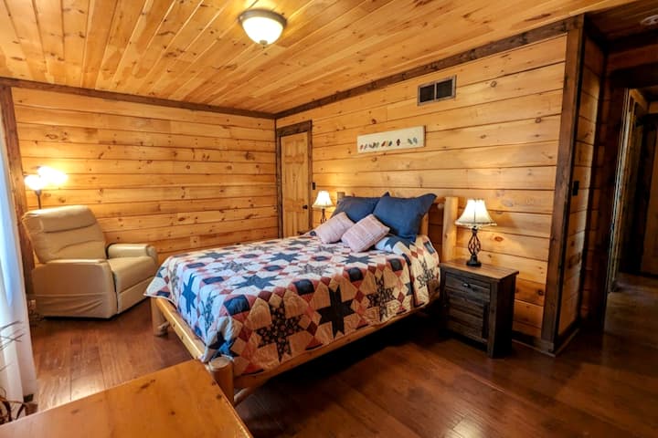 Main floor left bedroom. Queen size bed and power lift recliner.