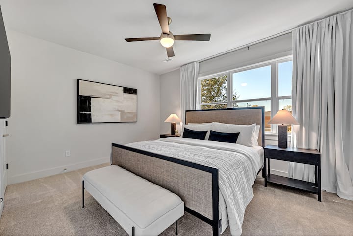 Our second upstairs bedroom has a king bed with black out curtains, smart TV, large walk in closet and cozy linens for a wonderful night sleep. Make sure to check the bedside tables for extra pillowcases and chargers to make your stay easy.