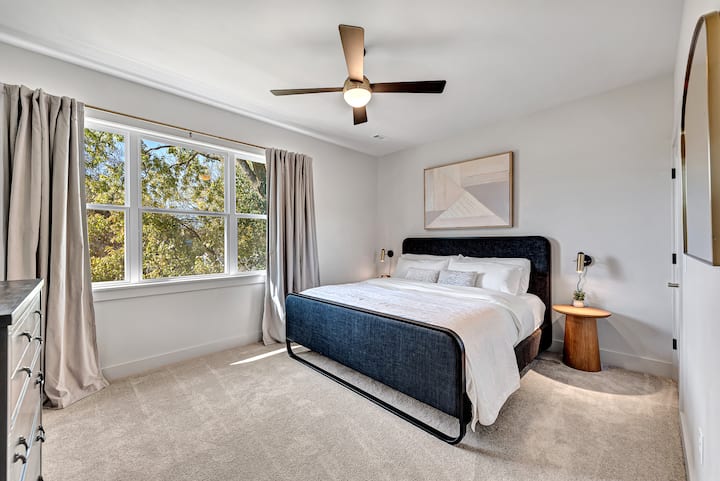 Our third upstairs bedroom has a king bed with black out curtains, smart TV, large walk in closet and cozy linens for a wonderful night sleep. Make sure to check the closet for extra pillowcases and chargers to make your stay easy.
