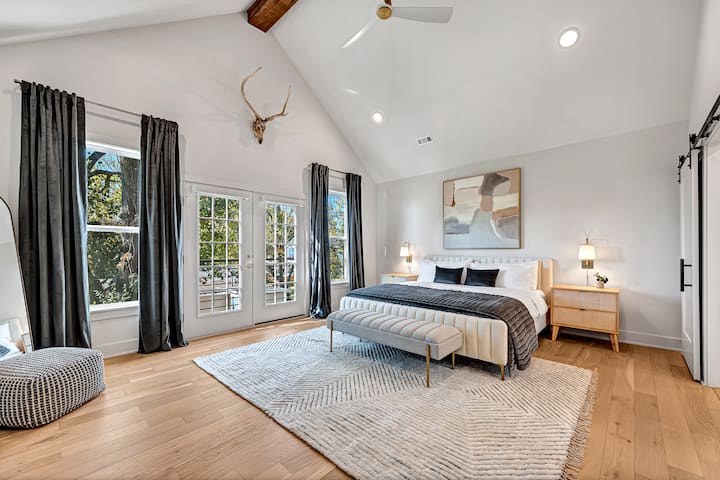 Welcome to the LUXurious primary suite. Open the French doors to our Juliet balcony for fresh air. We have a remote hidden by the curtains to drop all of the electric blinds for a peaceful night sleep. Enjoy satin pillowcases in the side tables:)