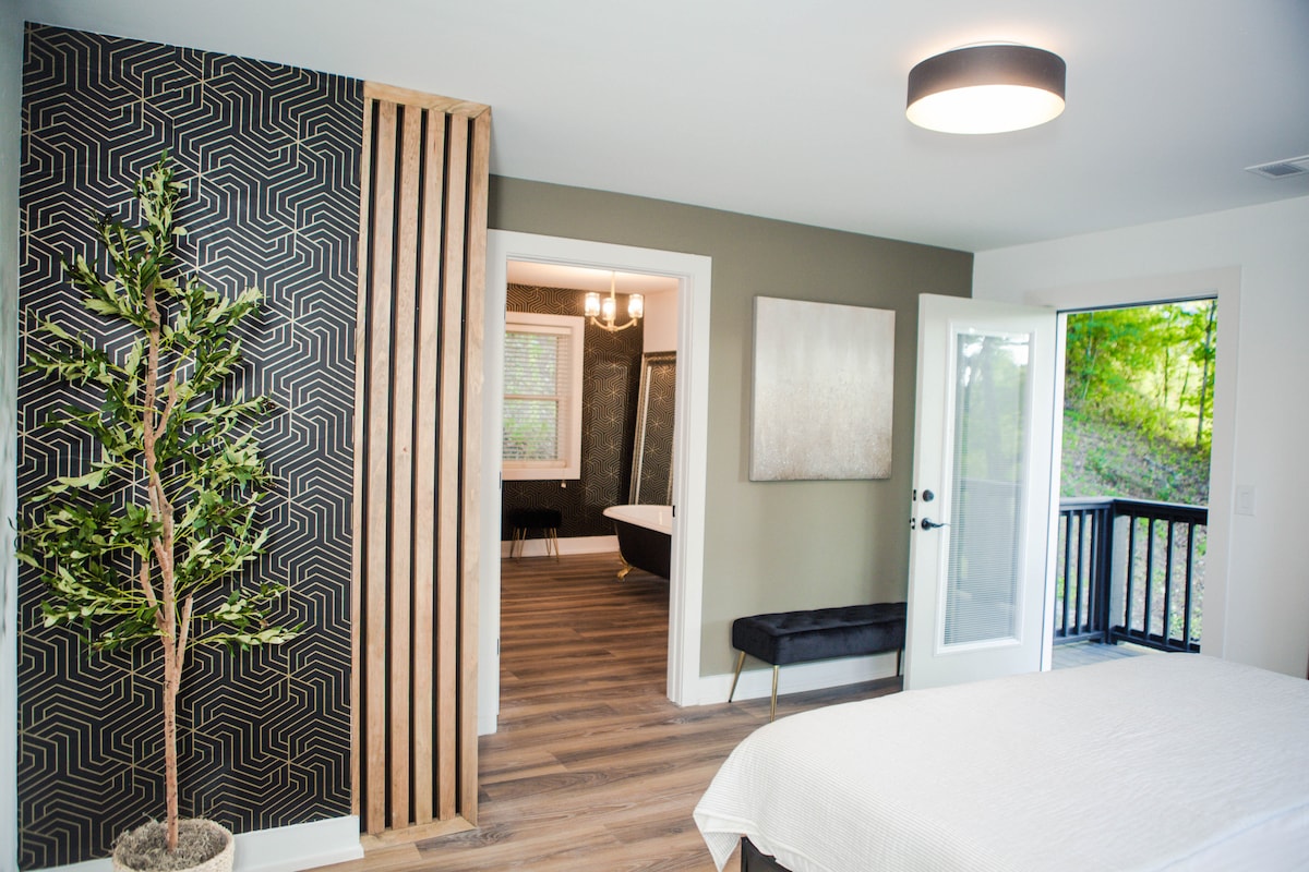 Primary bedroom with door open to the side deck.