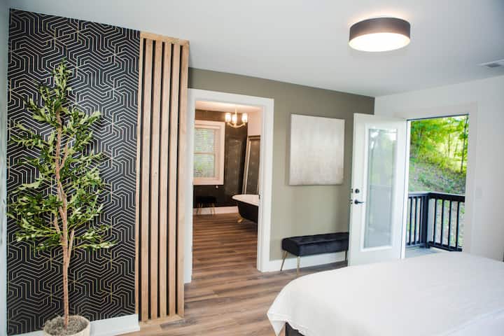 Primary bedroom with door open to the side deck.