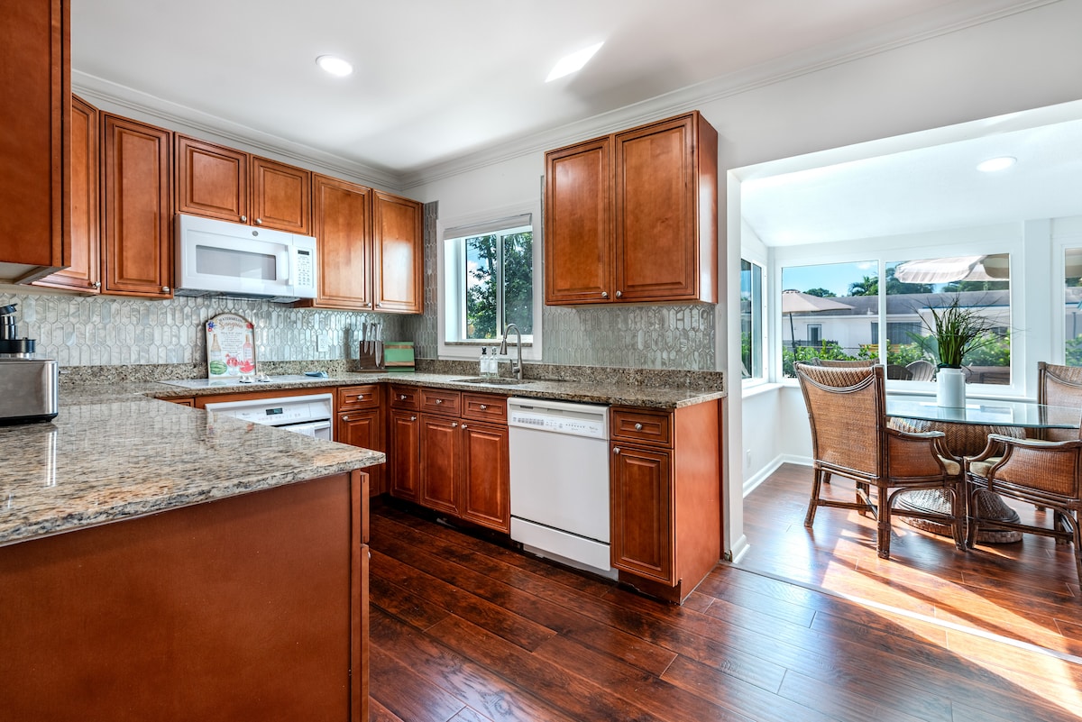 Modern, fully stocked kitchen with sleek appliances, ample counter space, and a stylish design.