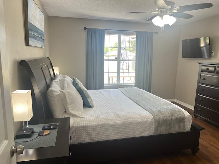 King bedroom with a plush mattress and adjustable head and foot bed. Lamps have usb with a multi charger. Roku Smart TV, black out curtains, en suite bathroom