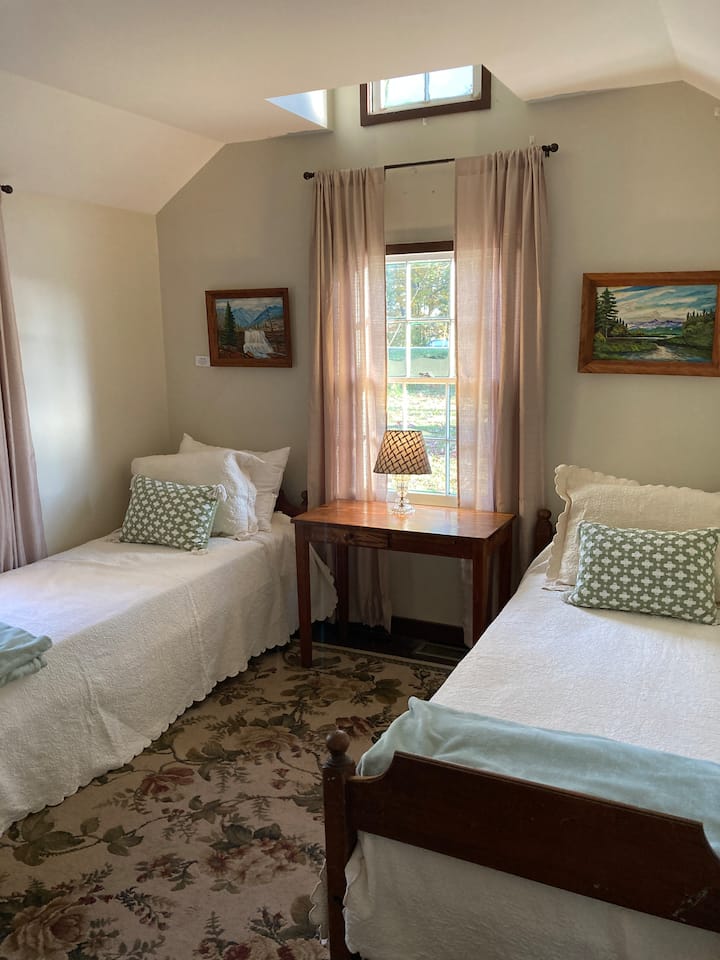 Two twin beds with brand new, comfort top mattresses to ensure a good nights sleep.  The beds were made in Arthurdale in 1934.  The paintings above the beds are original works of art by one of the original homesteaders.  