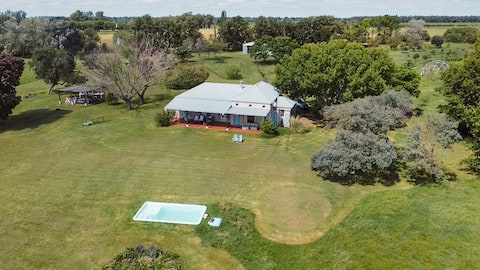 A field with a pool and river view