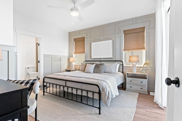 Bedroom 2: King bed with private en-suite bathroom, smart TV, and workspace