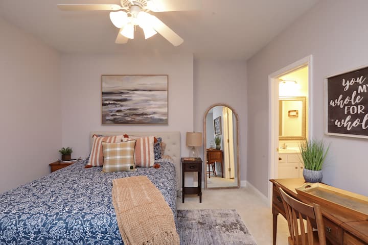 Bedroom 5 lower level with queen sized bed, large Flat Screen TV, and private Bath with tub.