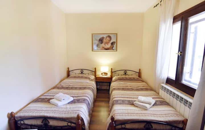 Спална соба 1 со два единечни кревета, ноќна масичка и ноќна ламба