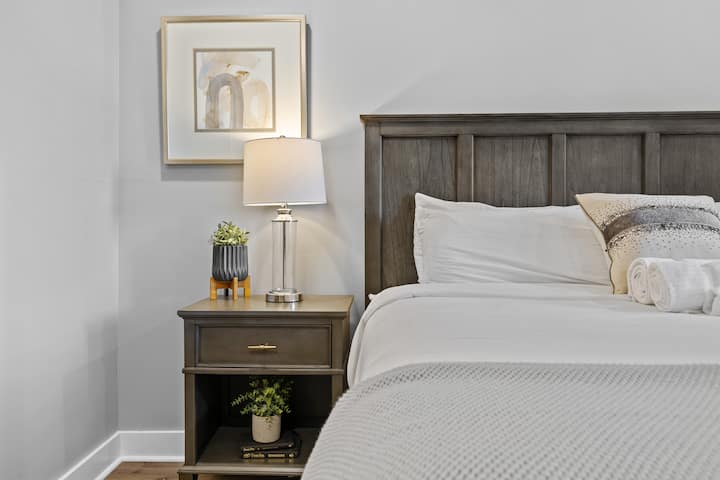 Luxurious king-size bedroom, private bath, TV, plush sheets.