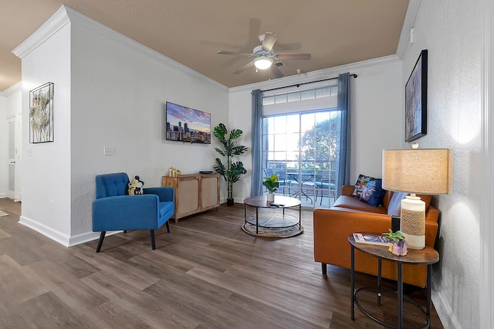 Relax in Style! This beautifully designed living space features modern decor, plush seating, and a Smart TV, leading out to a private screened-in patio for your morning coffee! 