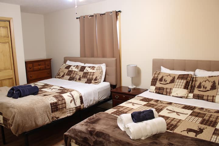 Lower level bedroom with two queen sized beds. 