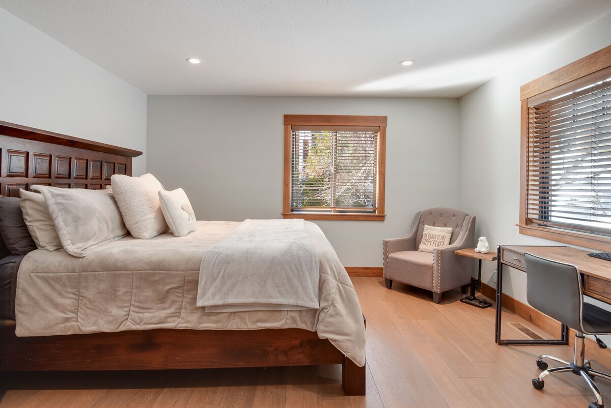 Master Bedroom with King Bed and Crib along Ensuite Bathroom, Accent chair. and Dedicated workspace