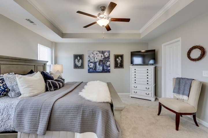 The uber-cozy primary Bedroom with king bed and new firm memory mattress is extremely peaceful on the third floor with ensuite bathroom with double vanity and large shower, large walk-in closet and 45" LED smart TV with streaming plus hair dryer, iro